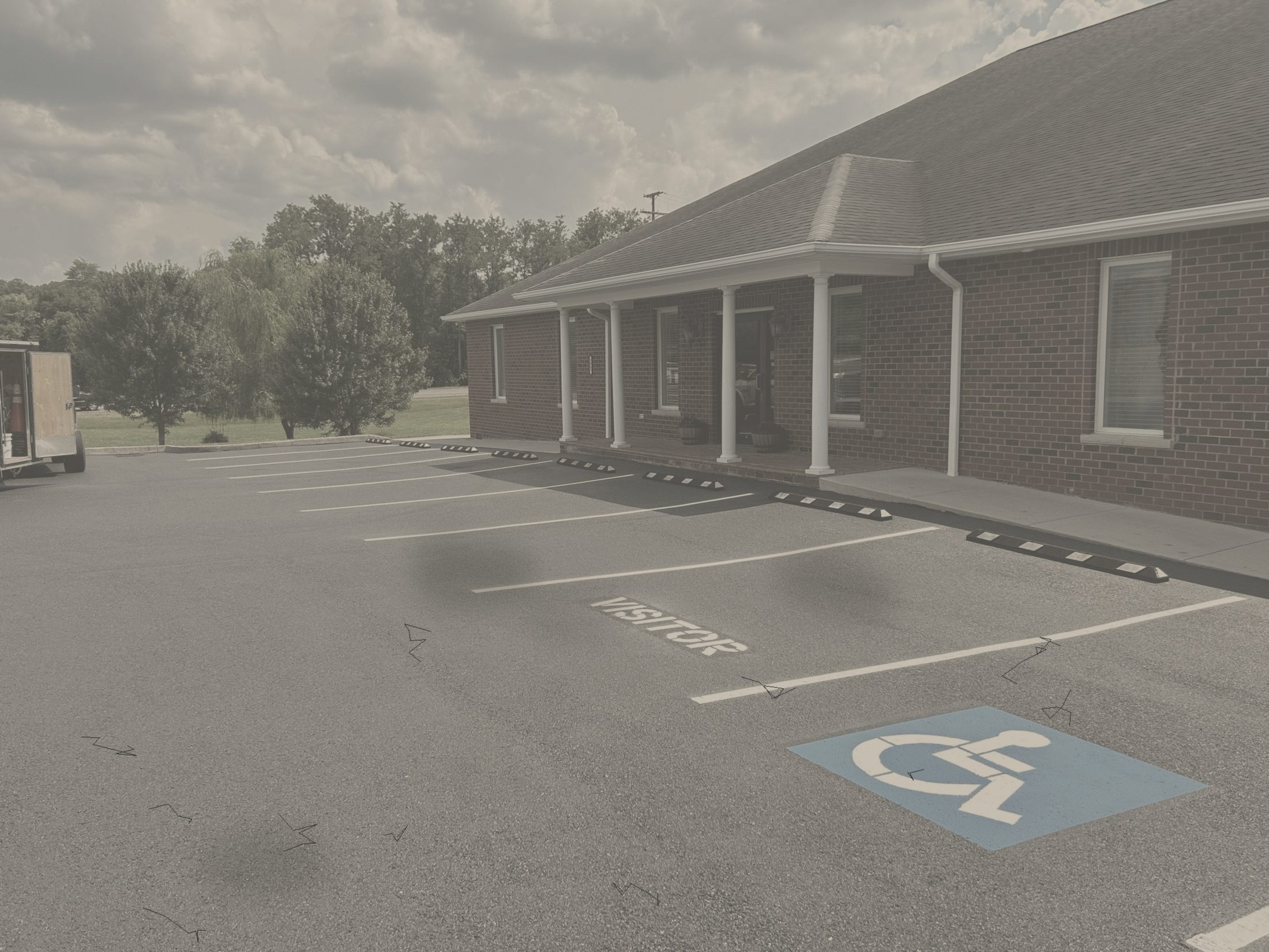 Worn, faded parking lot before LCS Striping work